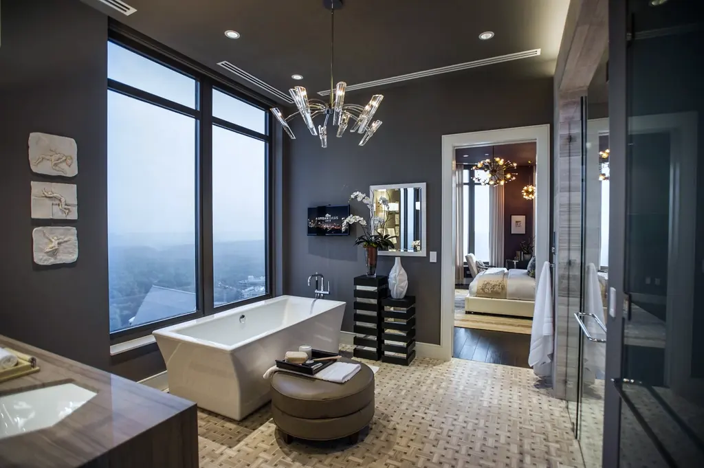 A modern bathroom with a glass shower and freestanding tub