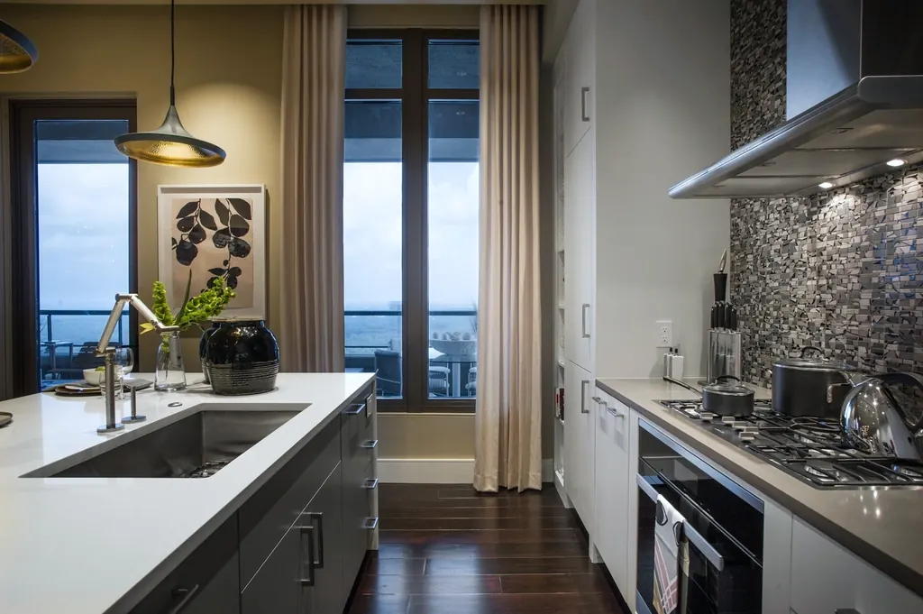 A modern kitchen with floor-to-ceiling windows